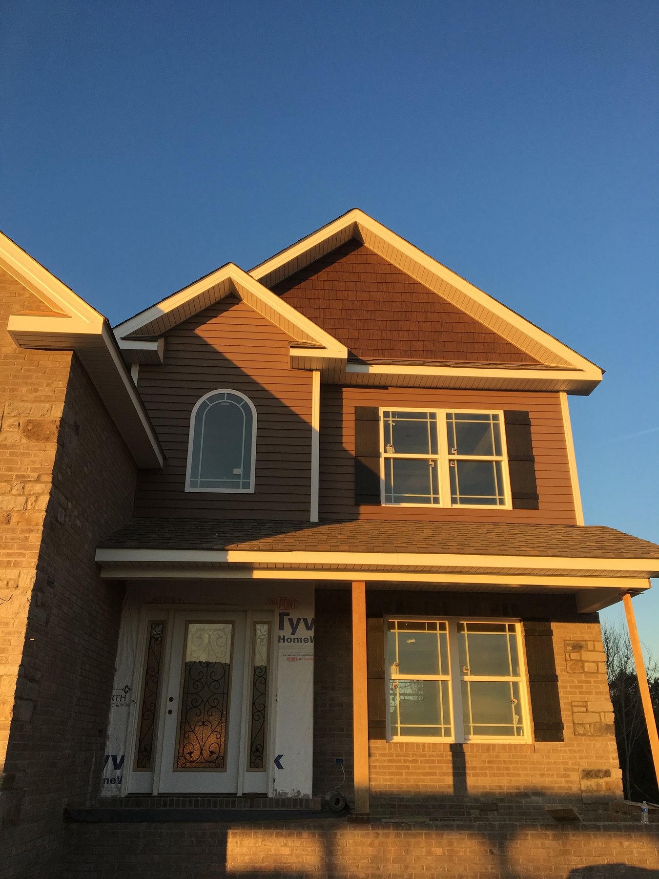 Craftsman home at golden hour with custom entry door