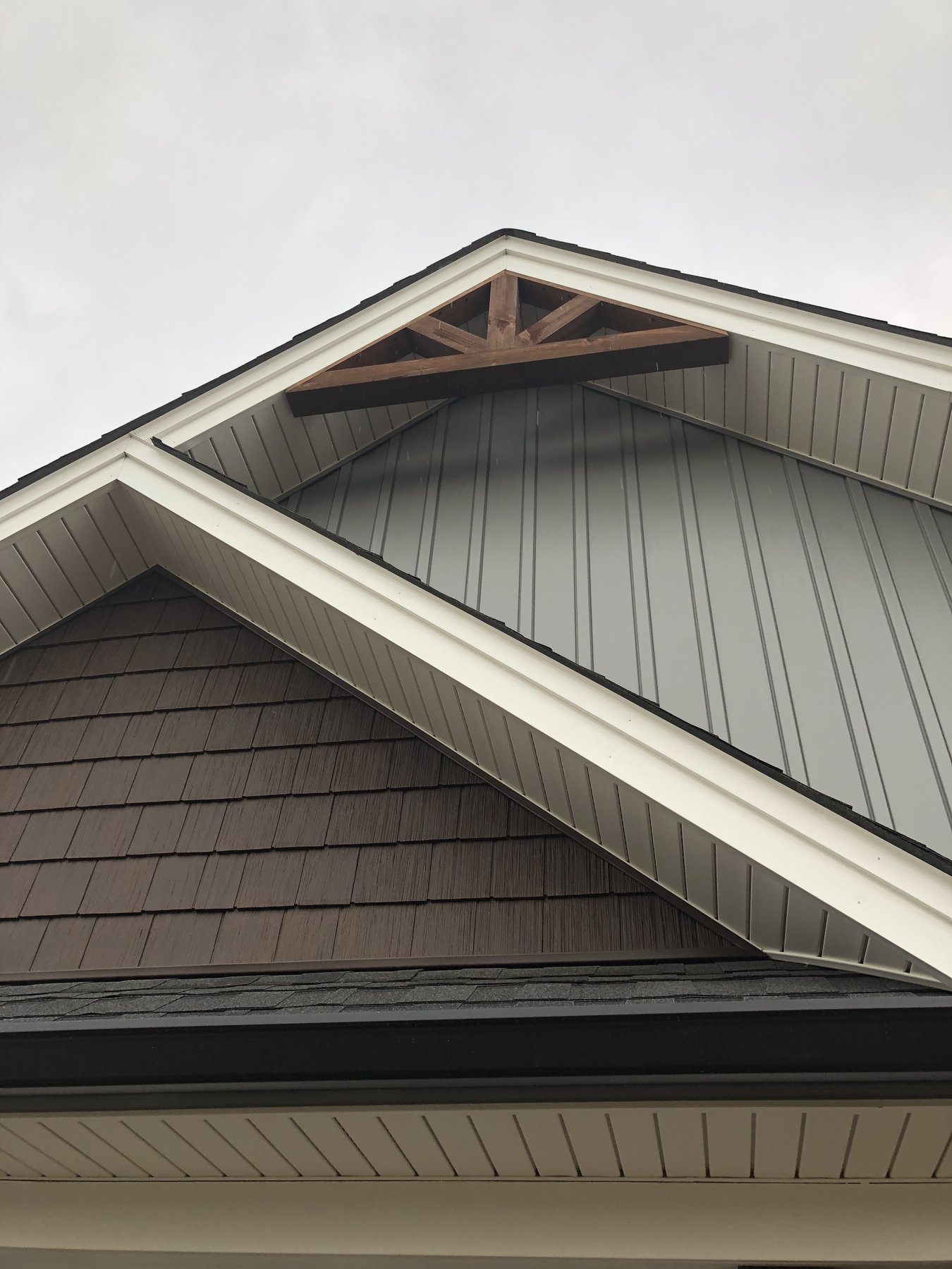 Gable roofline with shingle and metal accent