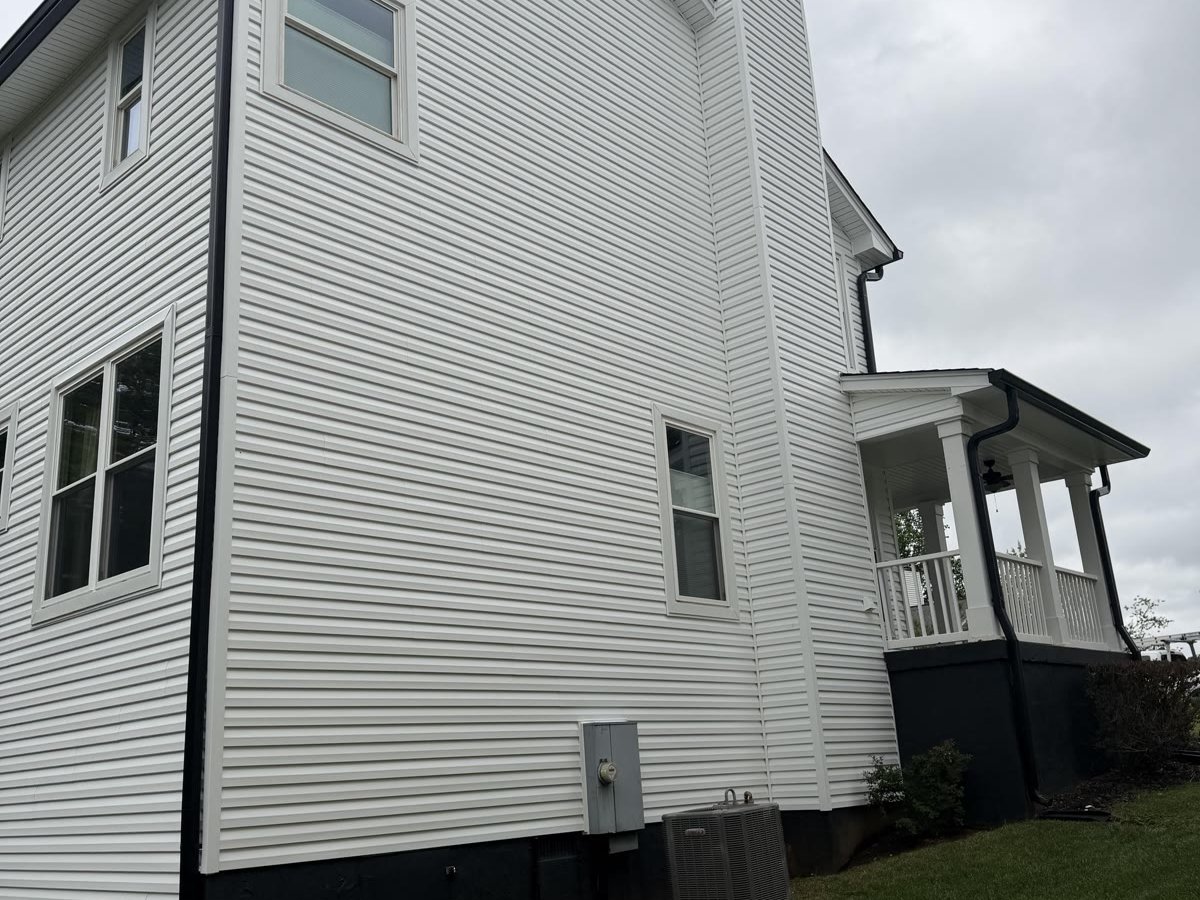 After: Crisp new white siding on the same Knoxville home, fully restored