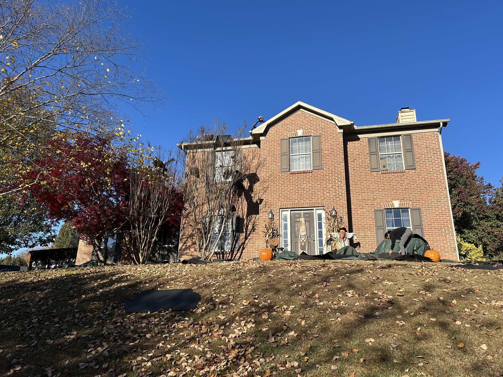 Before: Brick Knoxville home with aged painted exterior section above front entrance